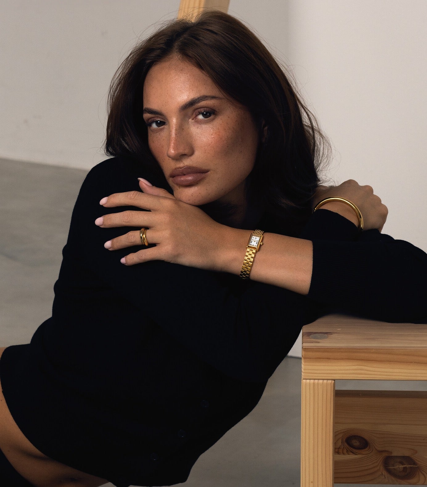 Black Friday VIP access: model wearing a gold bracelet watch, ring and bangle