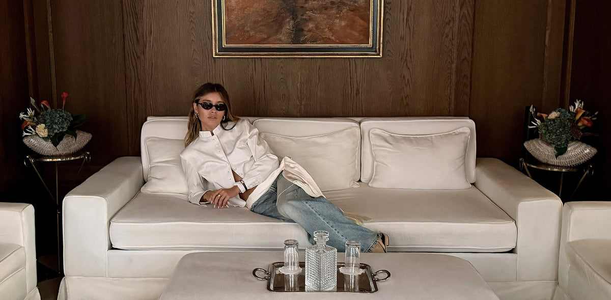 Sasha lounging on a white sofa at Hôtel Balzac in Paris